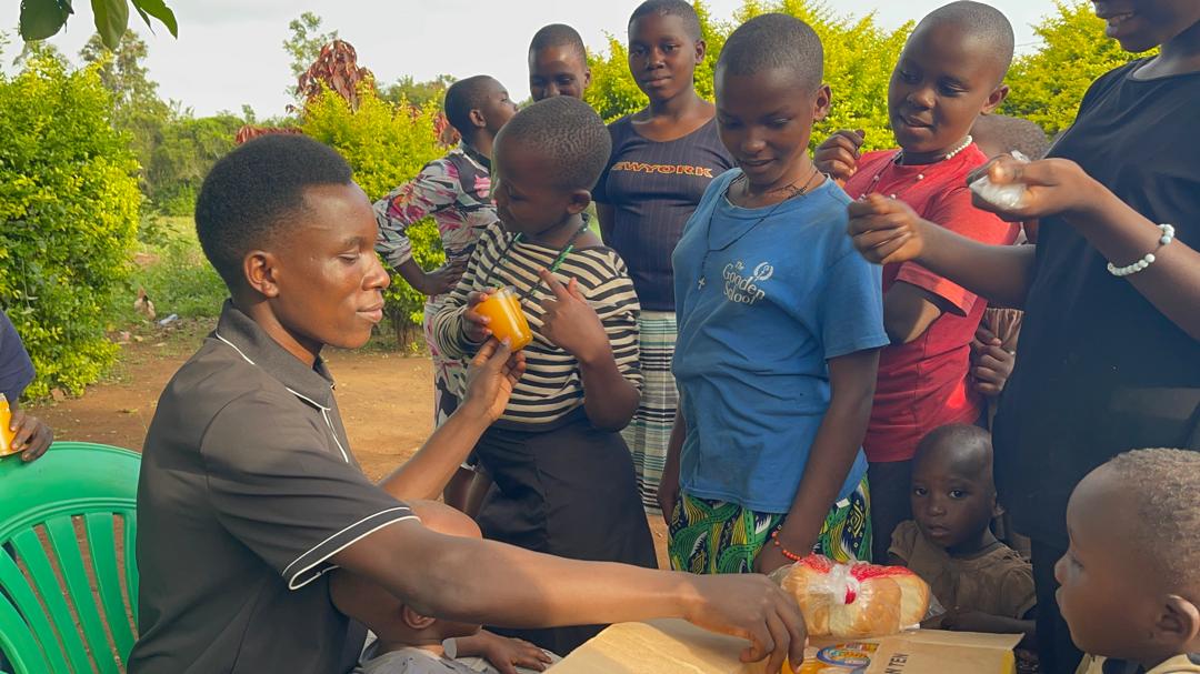 Children being served juice and bread at Destiny Transformation Home